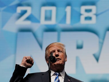 U.S. President Donald Trump makes a fist as he addresses the National Rifle Association (NRA) Convention in Dallas. Reuters