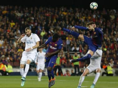 Barcelona's Gerard Pique (R) and Samuel Umtiti vie with Real Madrid's Karim Benzema (L). AFP