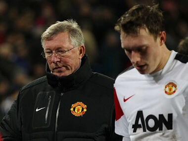 File image of former Manchester United manager Sir Alex Ferguson and Phil Jones. Reuters