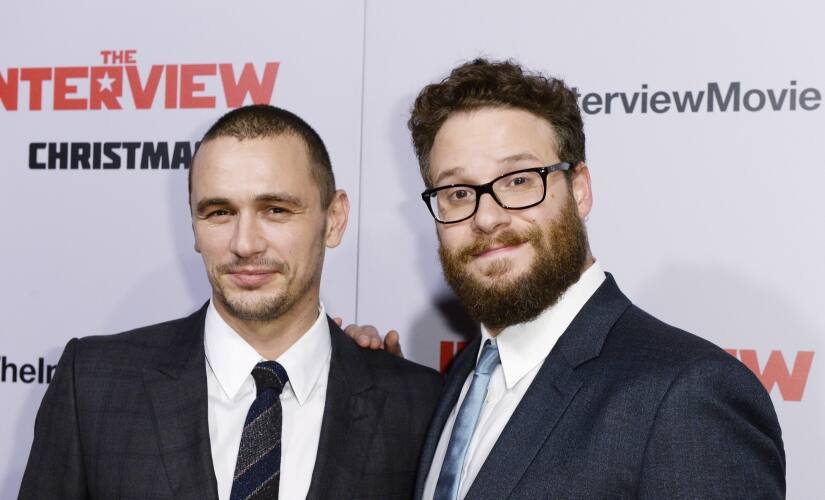Cast members James Franco (L) and Seth Rogen pose during premiere of the film 