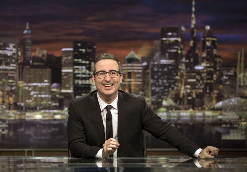 This image released by HBO shows John Oliver, host of "Last Week Tonight with John Oliver." Oliver said Sunday that he'd achieved all he'd wanted for the show by having an Australian animal hospital's special ward to treat a chlamydia outbreak among koalas named for him. He said, "goodbye, forever, everyone," as stagehands broke up his set around him. That inspired a wave of social media posts among fans wondering if he was serious. (Eric Liebowitz/HBO via AP)
