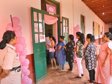 Voters stand in queue to cast their votes for Karnataka Assembly election 2018. PTI