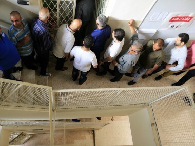 Lebanese voters queue to cast their vote at a ballot station on Sunday. AP