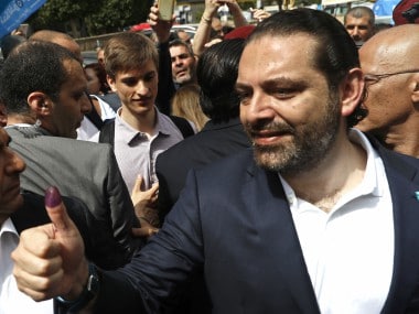 Lebanese prime minister Saad Hariri shows his inked finger on Sunday. AP