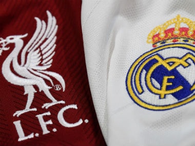 Respective logos of Real Madrid and Liverpool. AFP