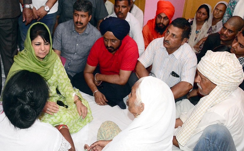 Jammu and Kashmir chief minister Mehbooba Mufti with the kin of those killed in ceasefire violation in RS Pura sector. Image courtesy Jamsheed Malik