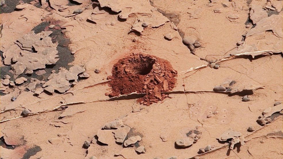 A close-up image of a 2-inch-deep hole produced using a new drilling technique for NASA's Curiosity rover. The hole is about 0.6 inches across (1.6 centimeters). This image was taken by Curiosity's Mast Camera (Mastcam) on Sol 2057. It has been white balanced and contrast-enhanced.