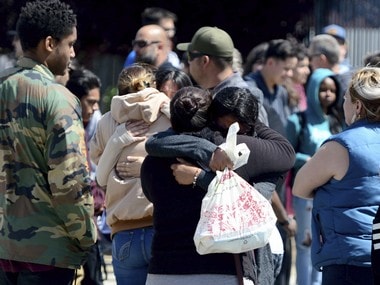 Students are reunited with family members outside Highland High School in Palmdale, California. AP