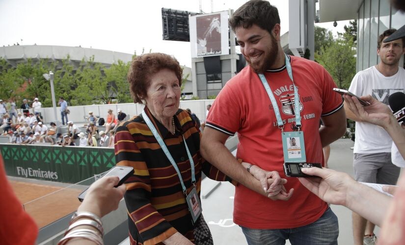Marco Trungelliti's grandmother Dafne Botta and his brother Andre answer reporters after he defeated Bernard Tomic at the French Open. AP