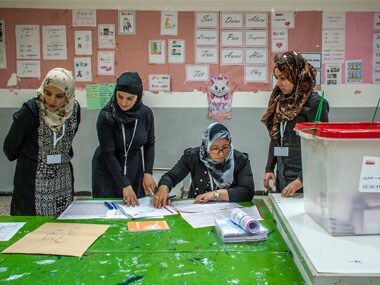 Election officials count votes at a polling station in Tunis. AP