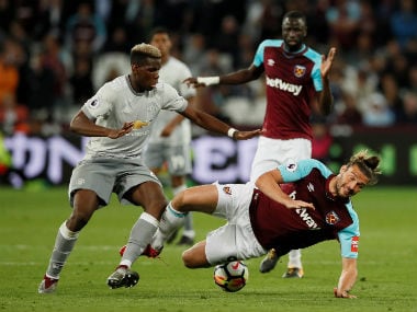 Manchester United's Paul Pogba in action with West Ham United's Andy Carroll. Reuters