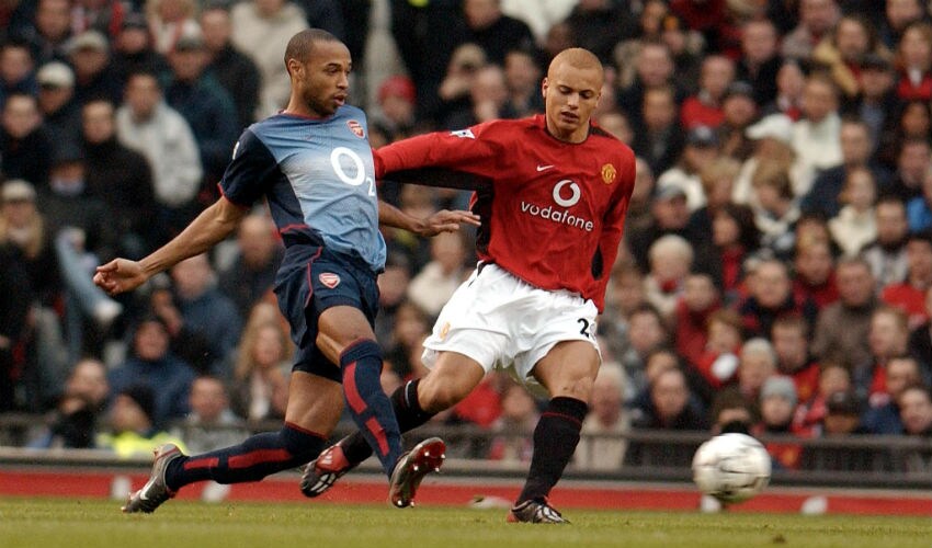 Manchester United's Wes Brown fights for the ball with Arsenal's Thierry Henry. AFP