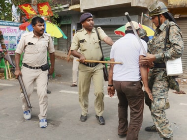 Security personnel lathi charge on political party workers who were allegedly involved in ransacking a polling booth and public property during Panchayat elections, at a village in Howrah district of West Bengal on Monday. PTI