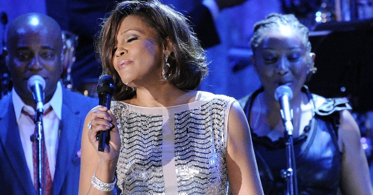 FILE - In this Feb. 13, 2011, file photo, singer Whitney Houston performs at the pre-Grammy gala & salute to industry icons with Clive Davis honoring David Geffen in Beverly Hills, Calif. Friends of Whitney Houston allege the singer was molested as a child by her cousin Dee Dee Warwick in a documentary that premiered Thursday May 17, 2018, at the Cannes Film Festival. (AP Photo/Mark J. Terrill, File)