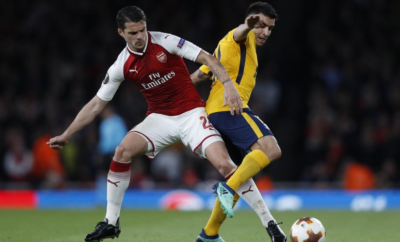 Arsenal's Granit Xhaka (L) vies with Atletico Madrid's Angel Correa during the UEFA Europa League first leg semi-final on 26 April, 2018. AFP