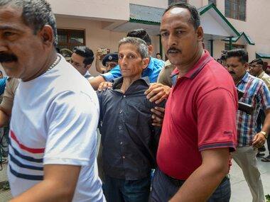 Vijay Singh Thakur being taken to court. PTI