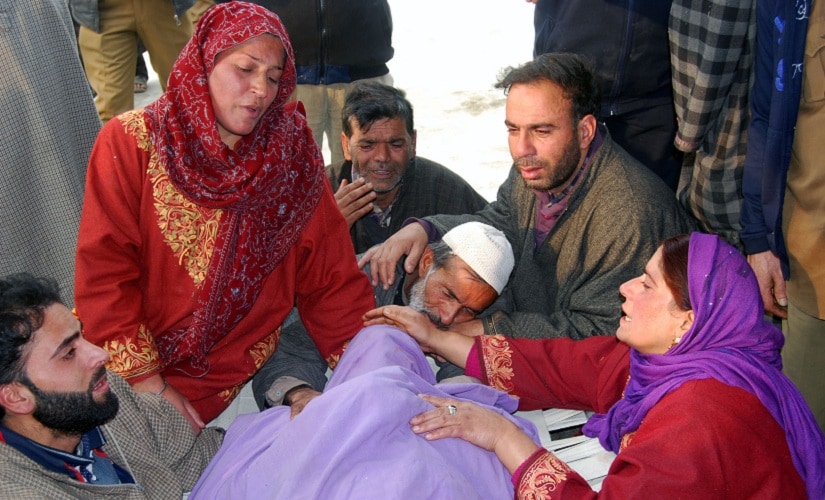 Mohammad Subhan Khanday (centre) kissing the forehead of his slain son. Image procured by Sameer Yasir
