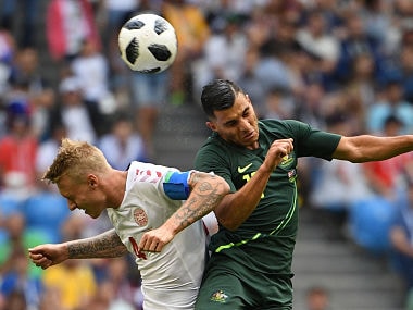 Denmark's defender Simon Kjaer (L) and Australia's forward Andrew Nabbout (R) go up for a header. AFP