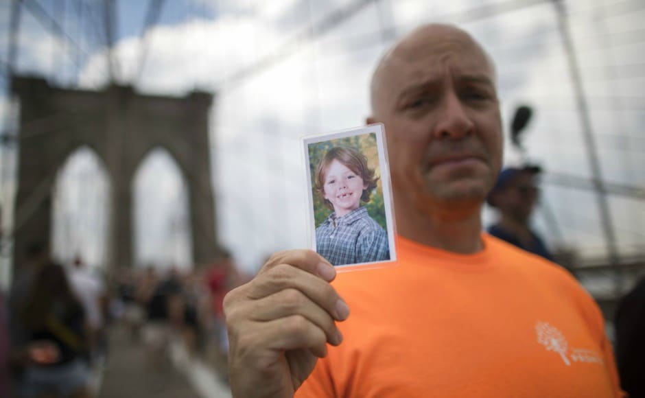 A demonstrator carries a prayer card for Daniel Gerard Barden, a victim of the Sandy Hook elementary school shooting, as he walks over the Brooklyn bridge during a march and rally against gun violence. AP A demonstrator carries a prayer card for Daniel Gerard Barden, a victim of the Sandy Hook elementary school shooting, as he walks over the Brooklyn bridge during a march and rally against gun violence. AP