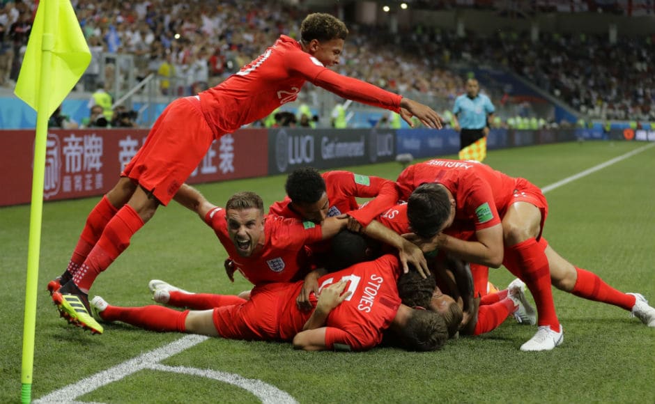 England players pile on each other after scoring the opening goal in their match against Tunisia. AP England players pile on each other after scoring the opening goal in their match against Tunisia. AP