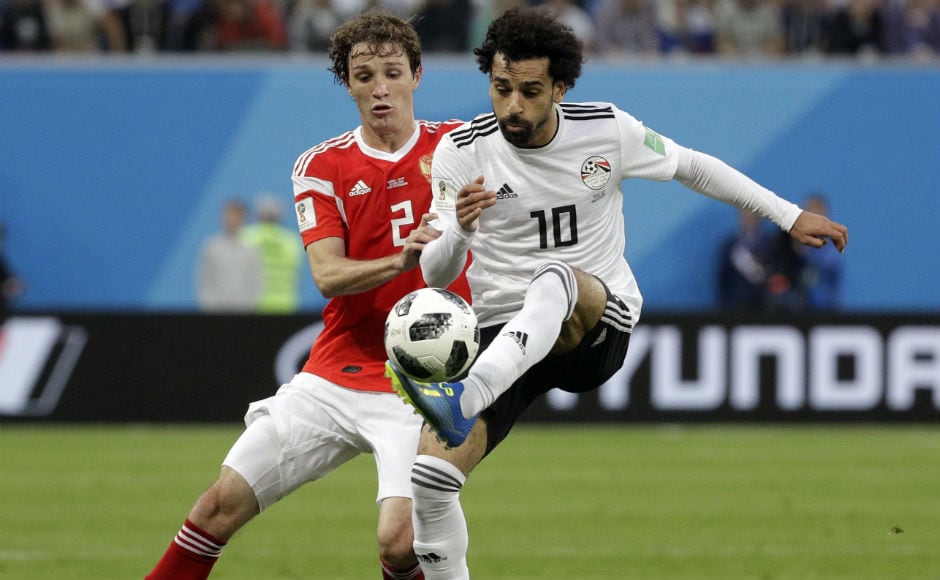 Russia's Mario Fernandes and Egypt's Mohamed Salah fight for the ball during their match at Saint Petersburg. AP Russia's Mario Fernandes and Egypt's Mohamed Salah fight for the ball during their match at Saint Petersburg. AP