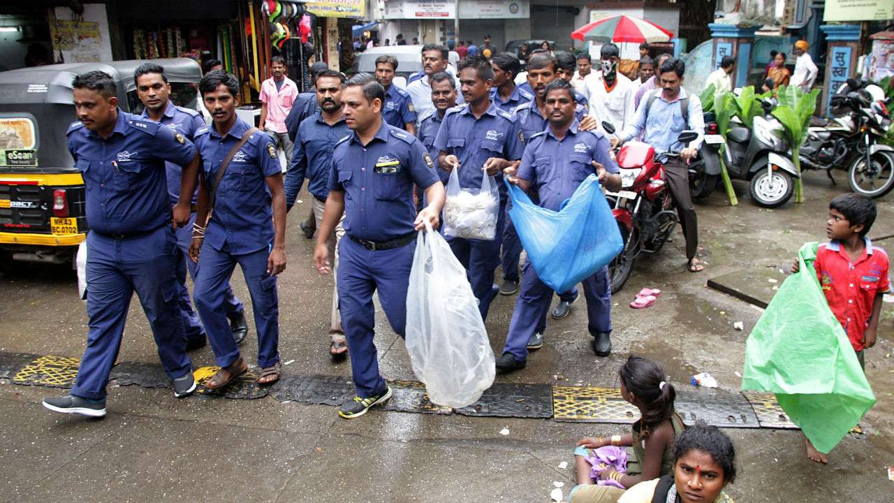 Civic workers inspect shops following the plastic ban in Maharashtra. PTI
