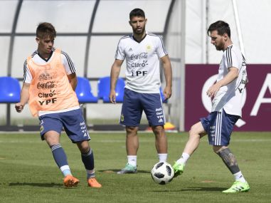Argentina's Lionel Messi (R) passes the ball next to teammate forward Sergio Aguero (C) during a training session. AFP
