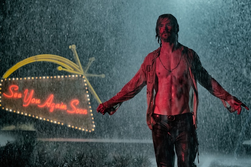 A shirtless Chris Hemsworth stands in the rain in the first look image for Drew Goddard's Bad Times at the El Royale. 20th Century Fox