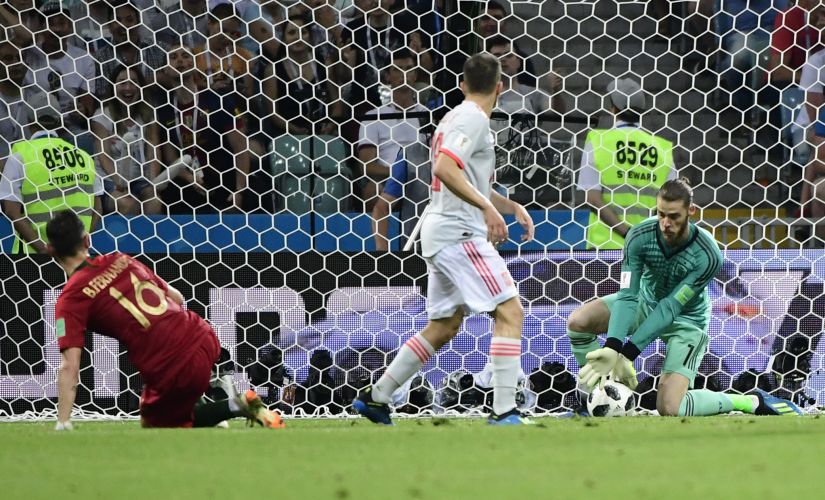 Spain's goalkeeper David De Gea (R) fails to block a second goal by Portugal's forward Cristiano Ronaldo (not in picture). AFP