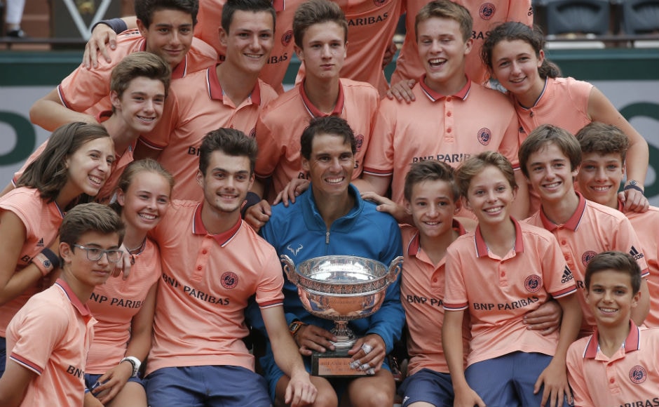 Spain's Rafael Nadal poses with ball girls and boys as he celebrates winning the men's final match of the French Open. AP Spain's Rafael Nadal poses with ball girls and boys as he celebrates winning the men's final match of the French Open. AP