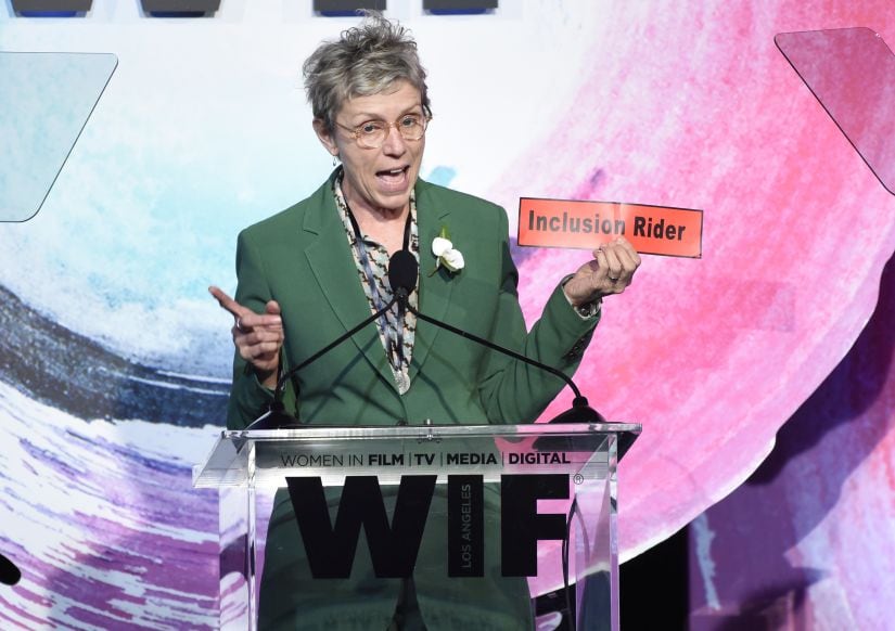 Frances McDormand, holding a sign that says Inclusion Rider, introduces Stacey L. Smith at the Women In Film Crystal and Lucy Awards at the Beverly Hilton Hotel on Wednesday, June 13, 2018, in Beverly Hills, Calif. (Photo by Chris Pizzello/Invision/AP)