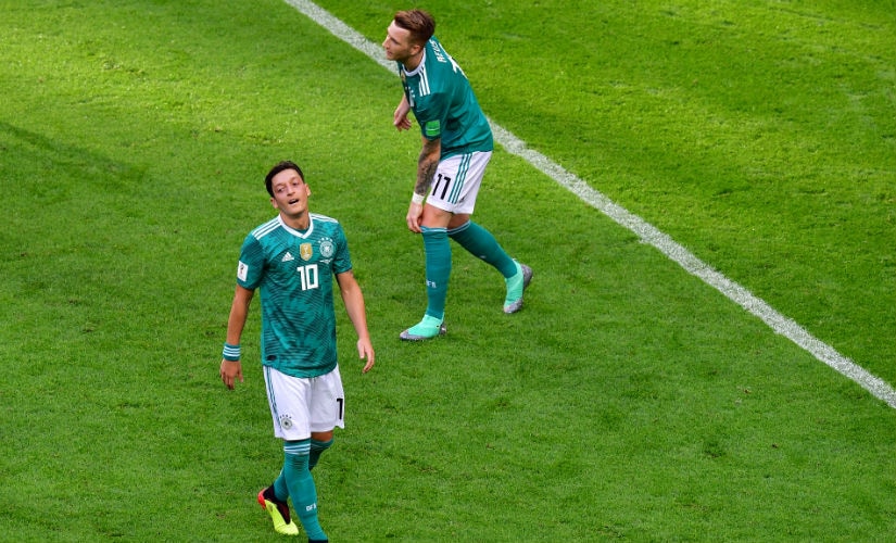 Germany's midfielder Mesut Ozil and forward Marco Reus (R) react to missed chances in the opening stages. AFP