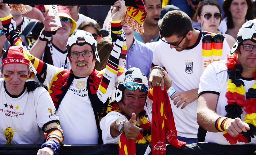 Fans of the German team cheer before the start of the Russia 2018 World Cup Group F football match between Germany and Mexico at the "Fanmeile" area in front of Berlin's landmark Brandenburg Gate on June 17, 2018. / AFP PHOTO / Tobias SCHWARZ
