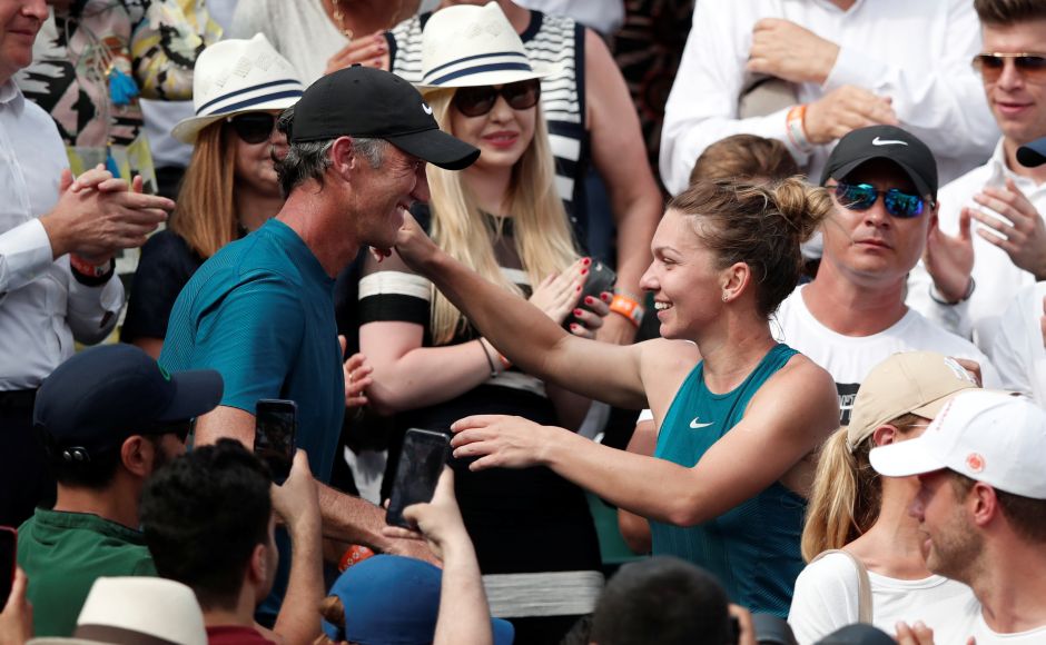 Simona Halep celebrates with her coach Darren Cahill after winning the final against Sloane Stephens. Halep climbed into the stands to embrace Romania’s former Olympic gymnastics champion Nadia Comaneci and 1978 Roland Garros winner Virginia Ruzici, the last Romanian to win a Grand Slam title. Reuters Simona Halep celebrates with her coach Darren Cahill after winning the final against Sloane Stephens. Halep climbed into the stands to embrace Romania’s former Olympic gymnastics champion Nadia Comaneci and 1978 Roland Garros winner Virginia Ruzici, the last Romanian to win a Grand Slam title. Reuters