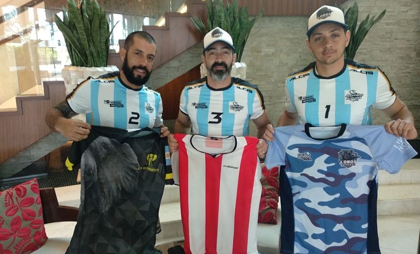 Argentina captain Rafael Acevedo (L), left-corner defender Gabriel Sacchi (C) and raider Federico Gramajo pose with jerseys of teams playing in Argentina's kabaddi league. Firstpost/Kaushal Shukla