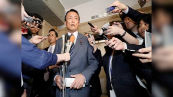 Japan finance minister Taro Aso returns a year's salary over land scandal; refuses to resign