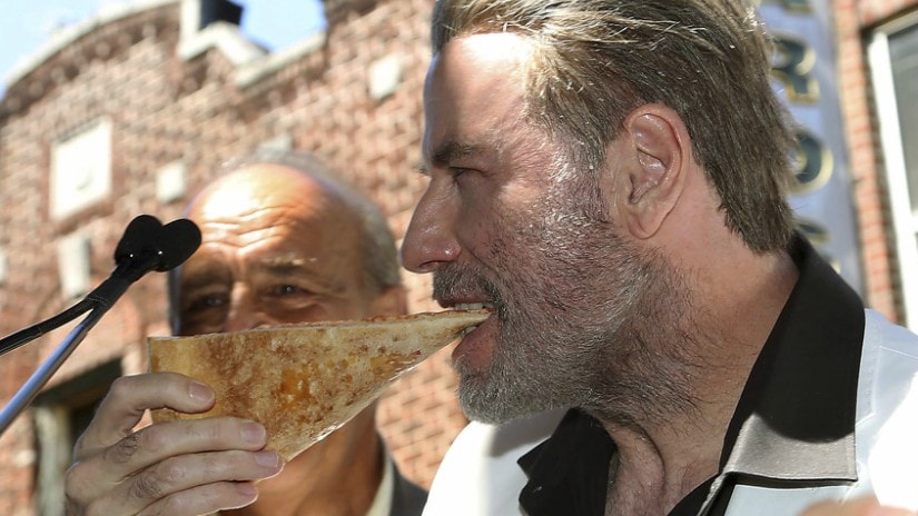 John Travolta eating a slice of pizza from Lenny's Pizzeria in the Brooklyn borough.AP/Starpix