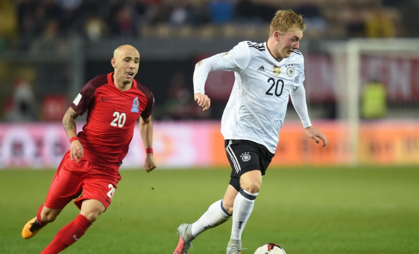 Azerbaijan's midfielder Richard Almeida (L) and Germany's midfielder Julian Brandt (R) vie for the ball. AFP