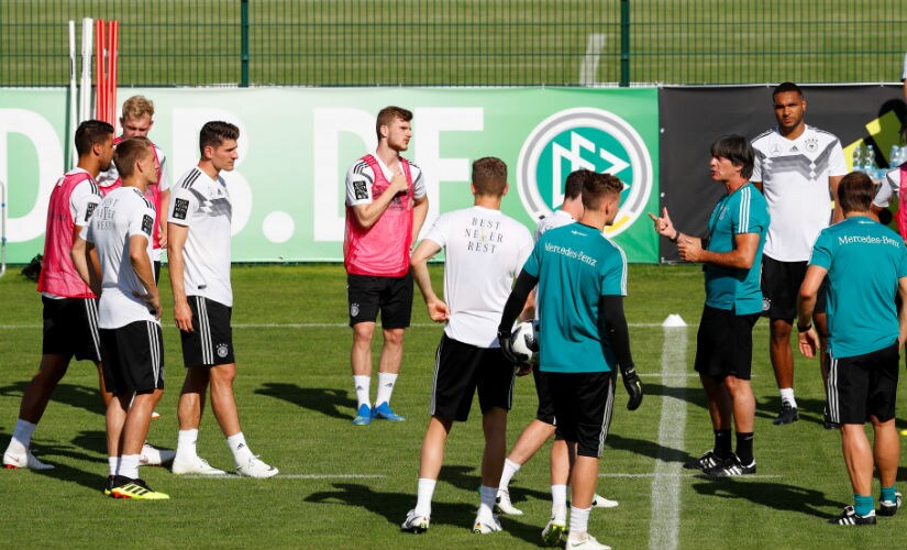 Germany coach Joachim Loew speaks with his players during training. Reuters