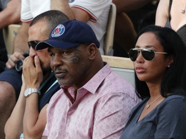 Mike Tyson, center, watches Serena Williams of the U.S. playing Germany's Julia Georges during their third round match. AP