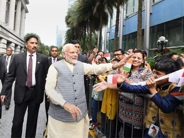 Prime Minister Narendra Modi being greeted by the members of Indian community upon his arrival in Singapore on Thursday. PTI