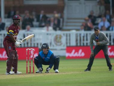 Nasser Hussain fields at slip with a microphone in his hand. Image credit: Twitter/@HomeOfCricekt