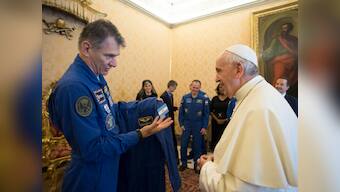 ISS Astronauts give Pope Francis his own personalised space suit which included a blue jumpsuit and a white cape
