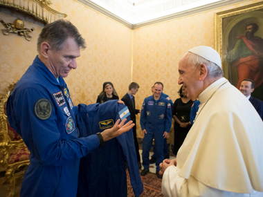 ISS Astronauts give Pope Francis his own personalised space suit which included a blue jumpsuit and a white cape ISS Astronauts give Pope Francis his own personalised space suit which included a blue jumpsuit and a white cape