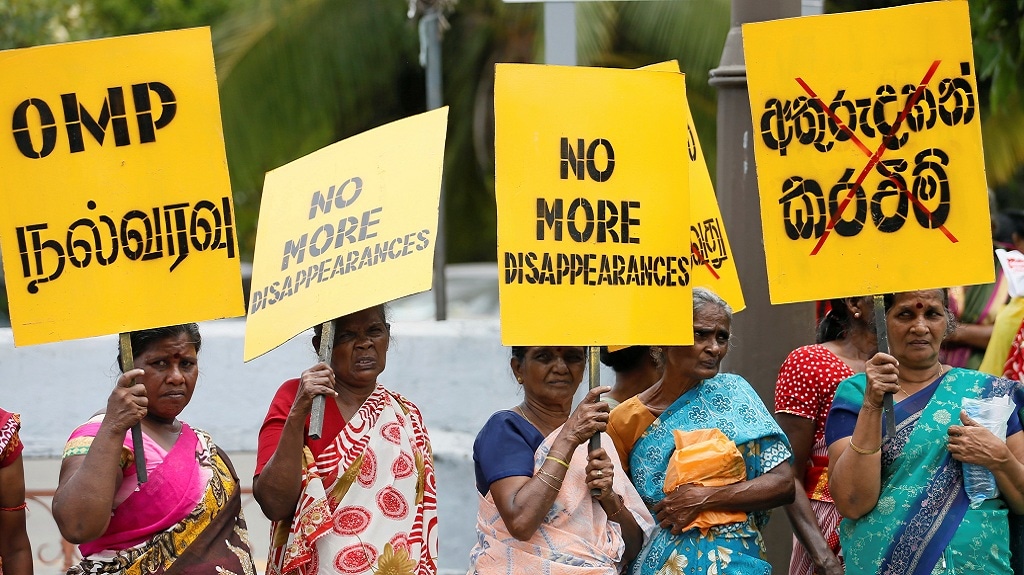 A group of women hold up placards at a silent protest to commemorate the International Day of the Victims of Enforced Disappearances in Colombo. — REUTERS