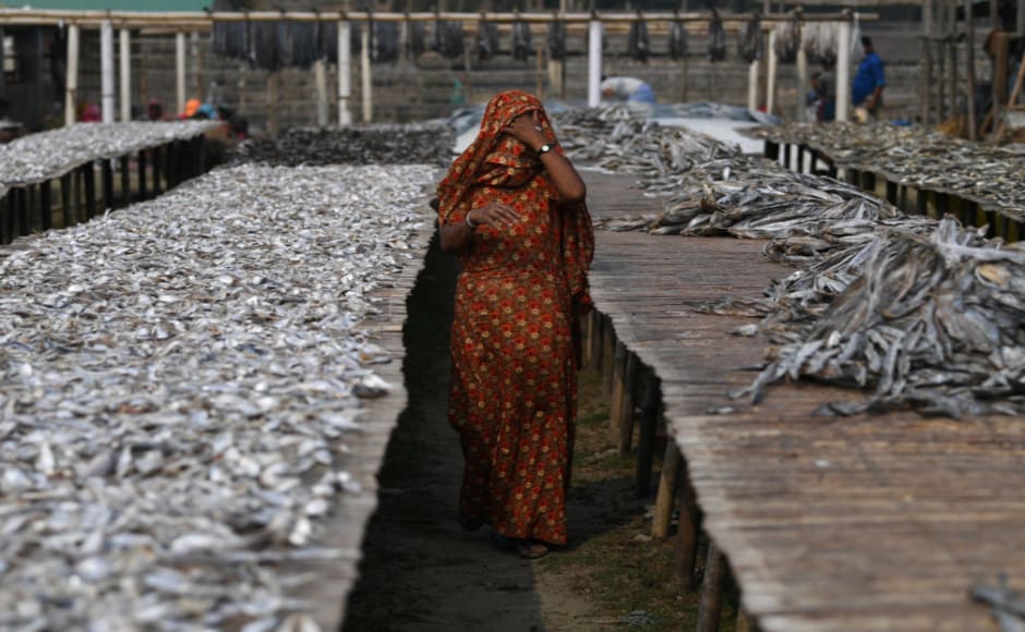 The women have found work drying fish at a yard in nearby Nazirartek, for a daily takehome of 100-200 taka ($1.20-$2.40). Reuters/Coldagh Kilcoyne The women have found work drying fish at a yard in nearby Nazirartek, for a daily takehome of 100-200 taka ($1.20-$2.40). Reuters/Coldagh Kilcoyne