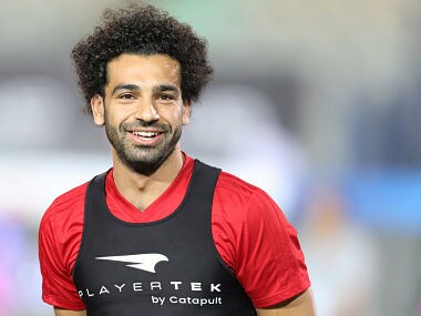 Egypt's Mohamed Salah smiles next to his teammates in Cairo international stadium in Cairo. Reuters
