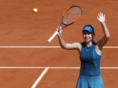 Simona Halep waves after defeating Garbine Muguruza during their semi-final match. AP