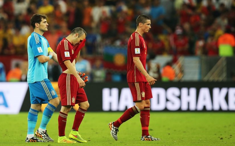 Spain's Fernando Torres (R), Andres Iniesta (C) and Iker Casillas look dejected at the end of the match against Chile at the 2014 World Cup. Reuters