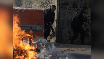 Violence between army-backed police and criminal gangs in Rio de Janeiro kills seven including 14-year-old boy